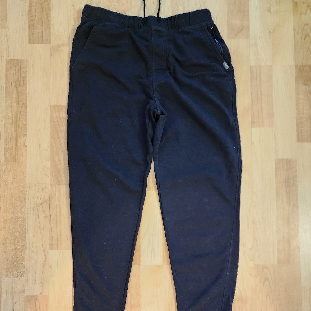 Black joggers with zipped pockets.